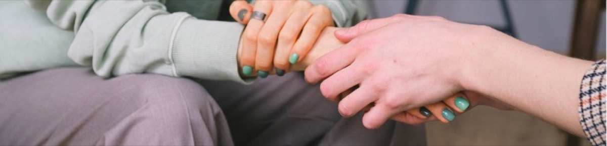 Hands fitting together the last pieces of a jigsaw puzzle